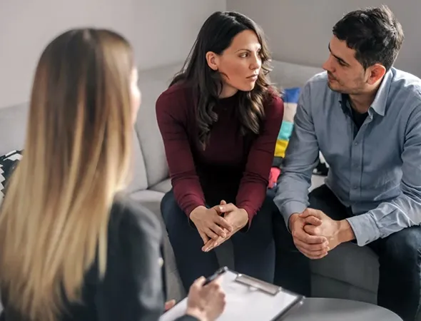 Couple learning to express emotions and needs during a coaching session