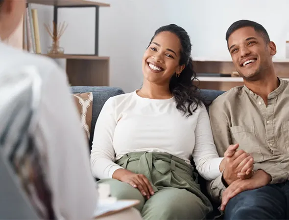 Couple working to rebuild emotional connection during a coaching session