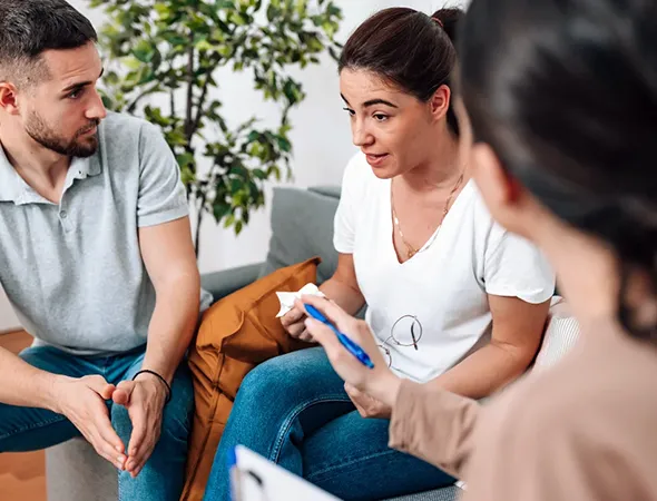 Married couple discussing a difficult separation decision with a coach